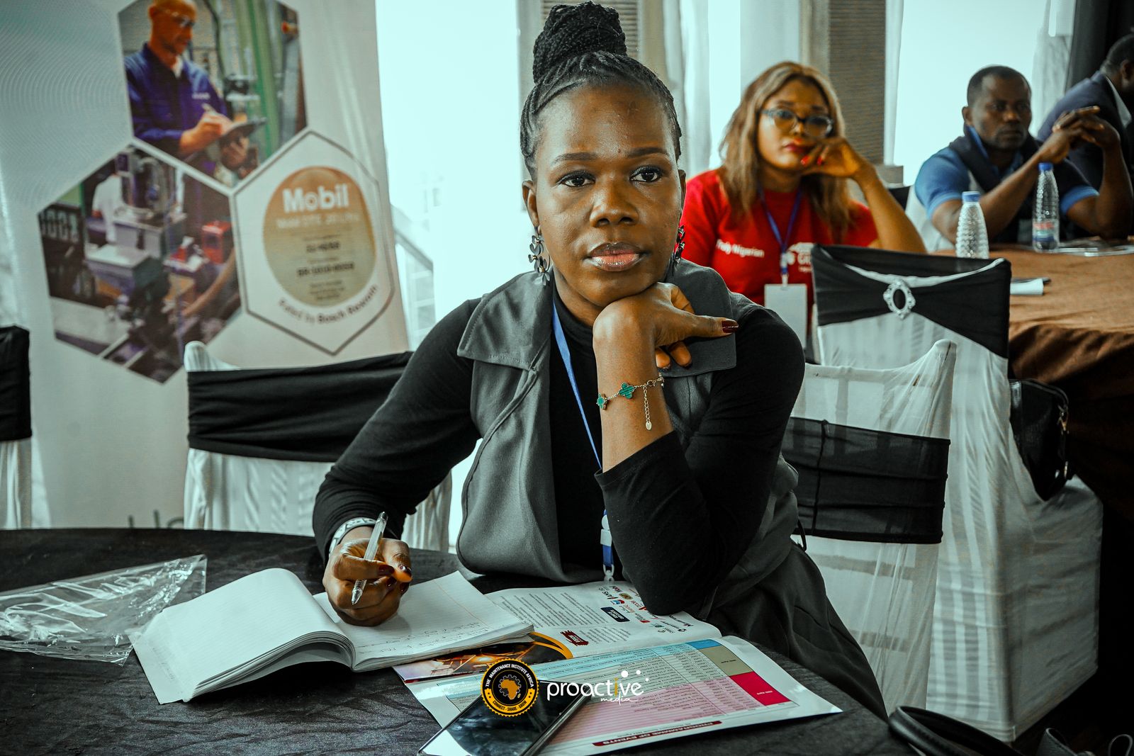 A delegate taking notes during a session