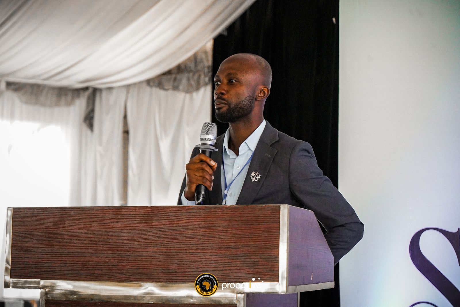 A speaker presenting at the podium during a previous edition